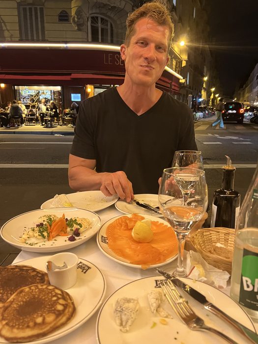 Jesse Henry at a restaurant table in Paris, France